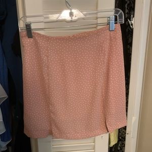 Mini pink skirt with white polka dots